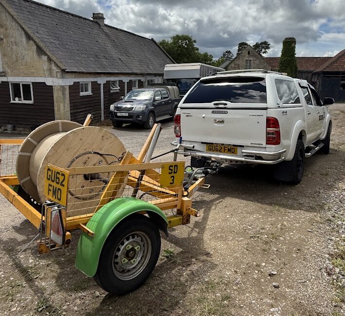 Pickup truck with a fiber drum trailer